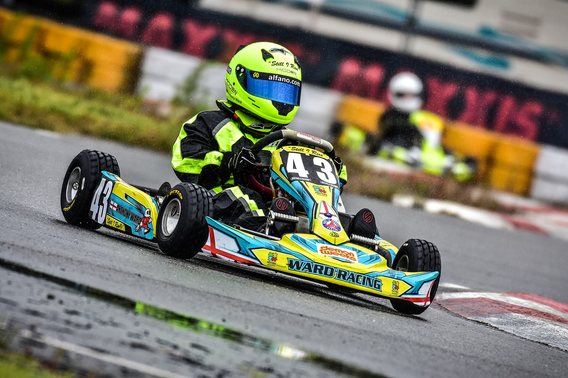 Karts racing in wet conditions on a rain-soaked track
