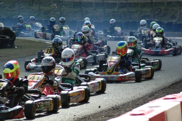 Karts lined up in rolling start formation on grid