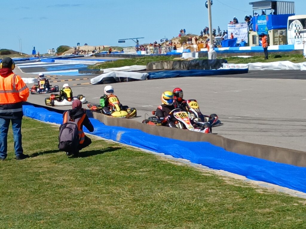 Karts spread out with visible gaps between them on track