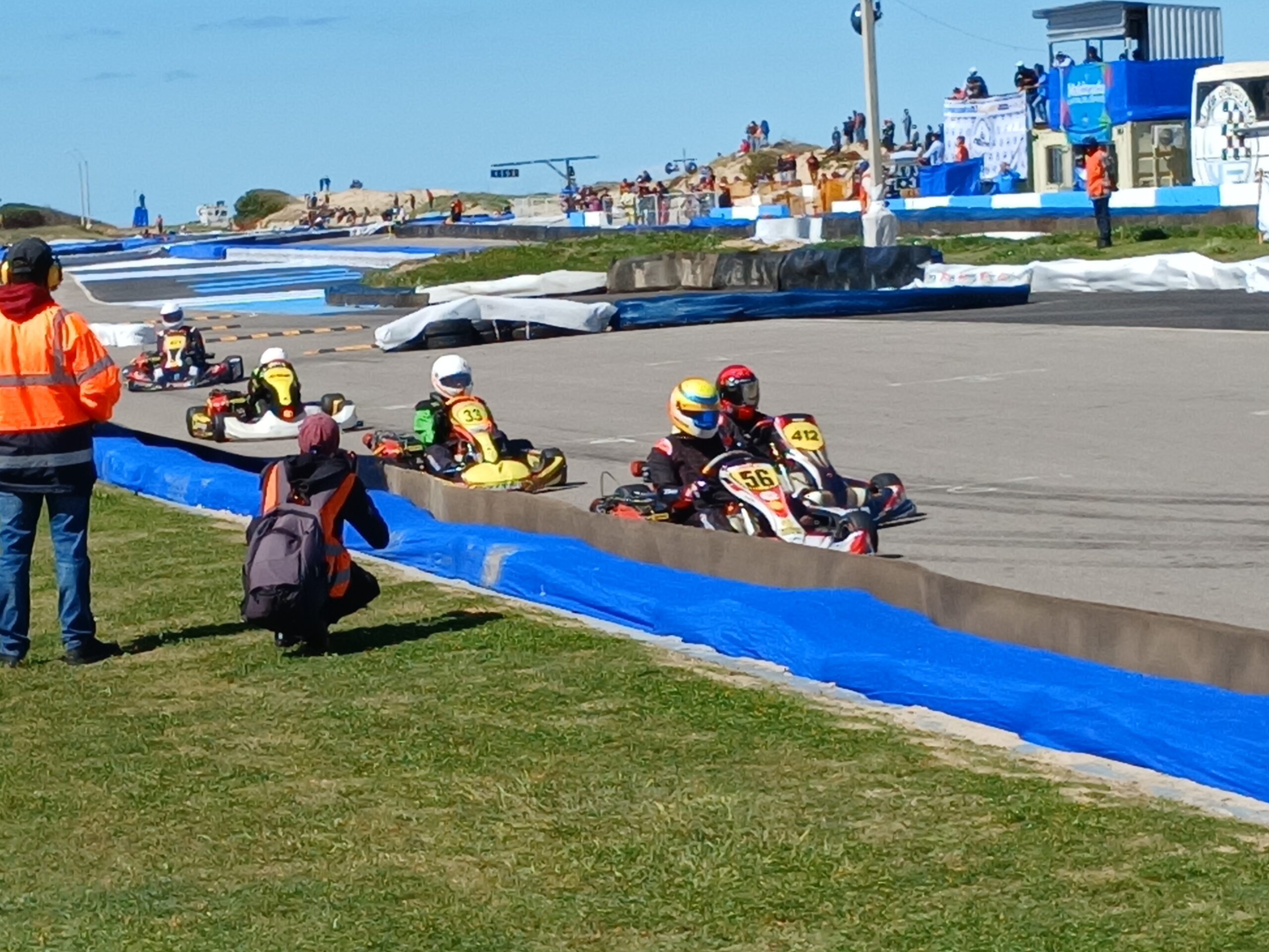 Karts spread out with visible gaps between them on track