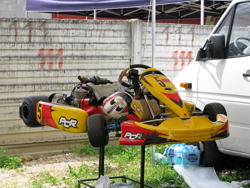 Racing kart on a paddock stand showing its rigid chassis with no suspension
