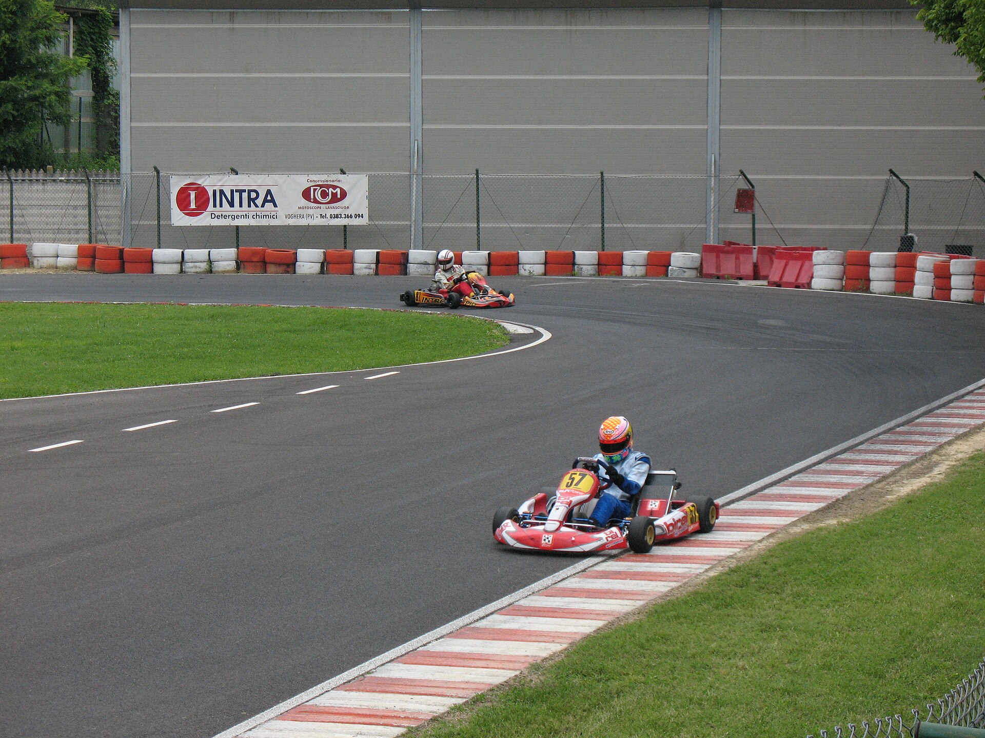 Kart at corner exit with its wheels riding the exit kerb