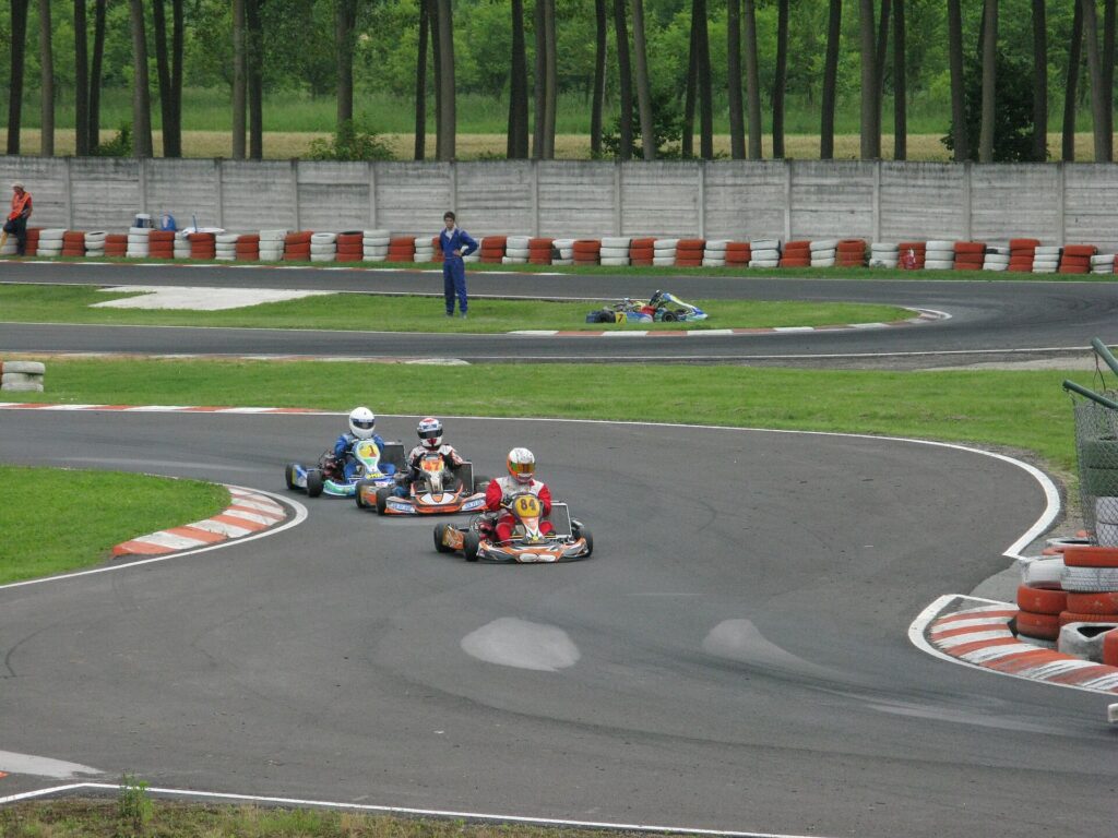 Karts through a corner with kerbs on both the inside and outside edges