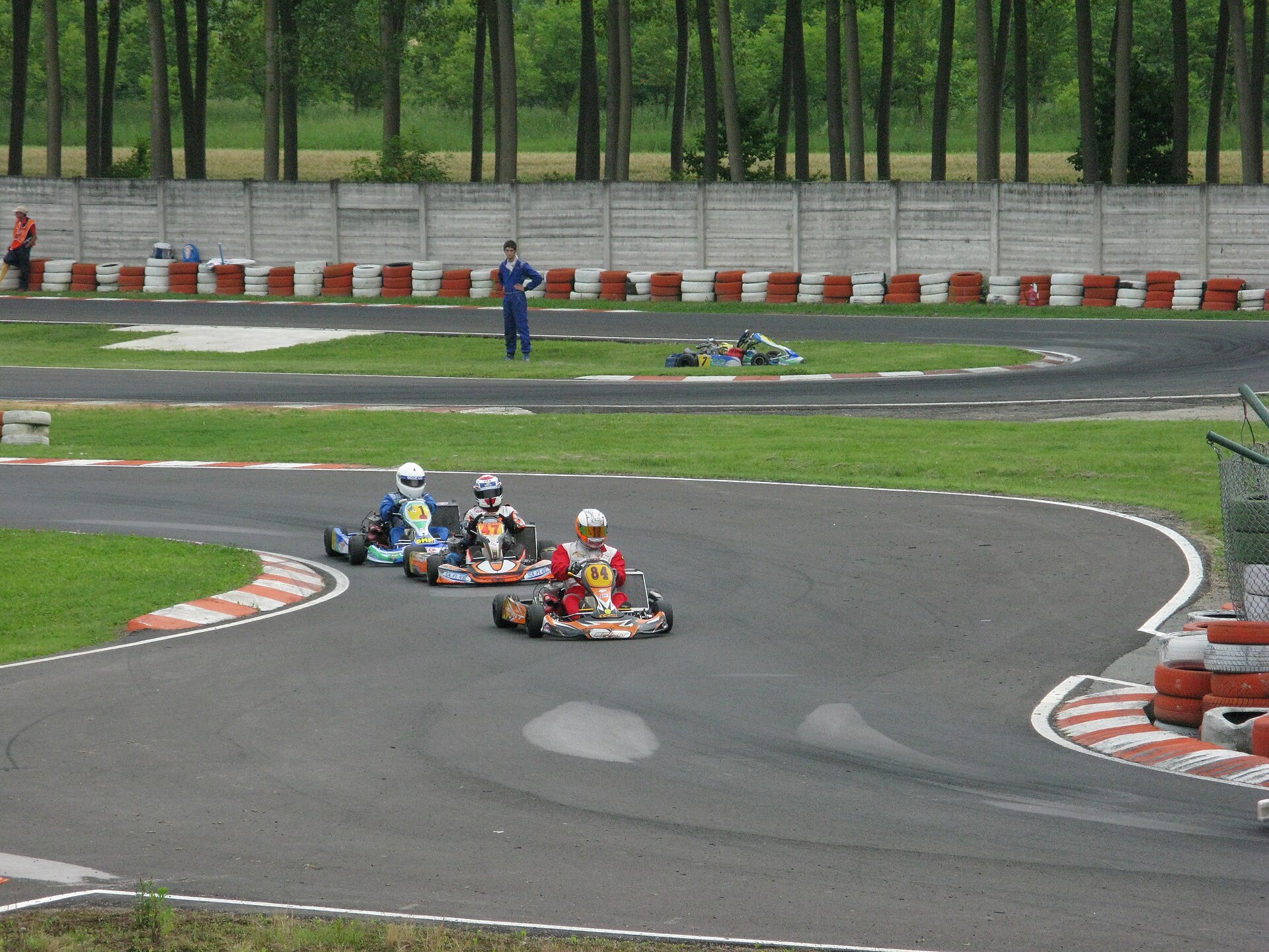 Karts through a corner with kerbs on both the inside and outside edges