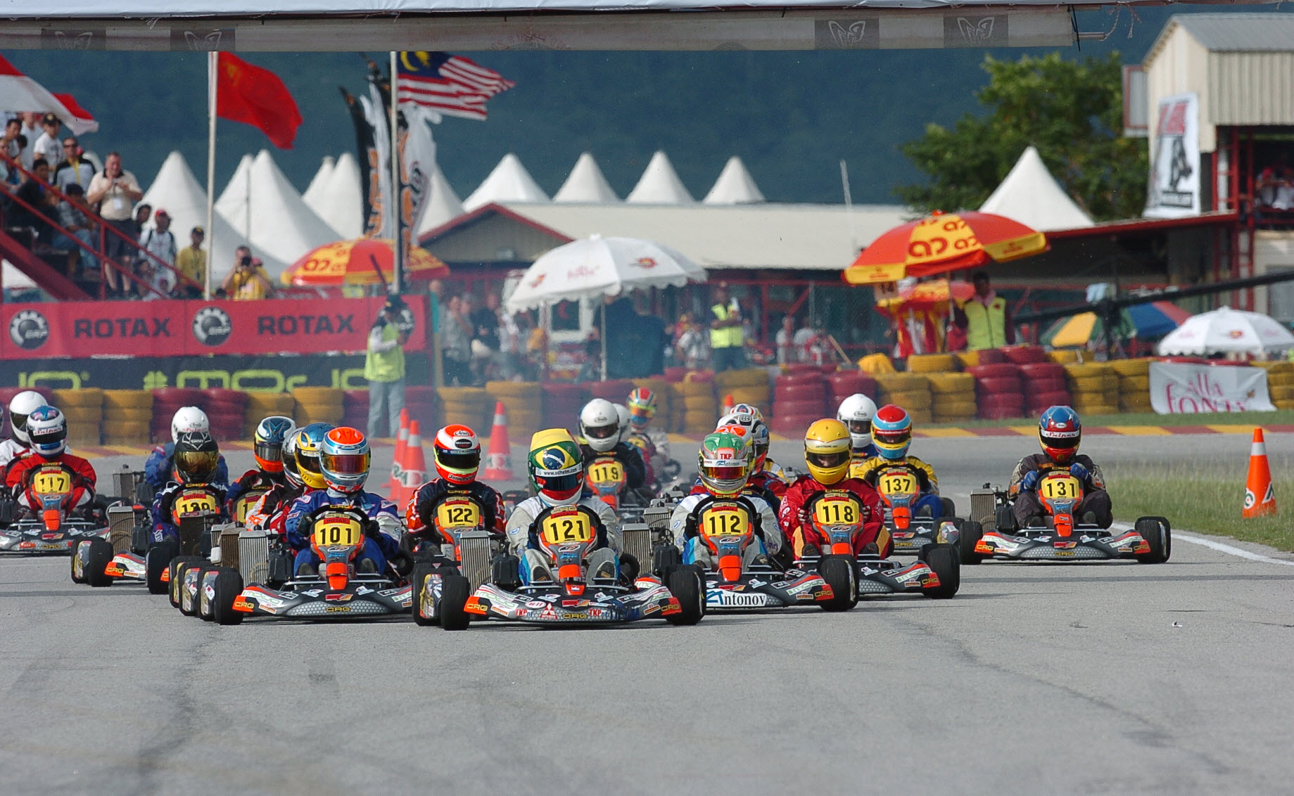 Full grid of race karts launching from a standing start at the Rotax Max Grand Finals