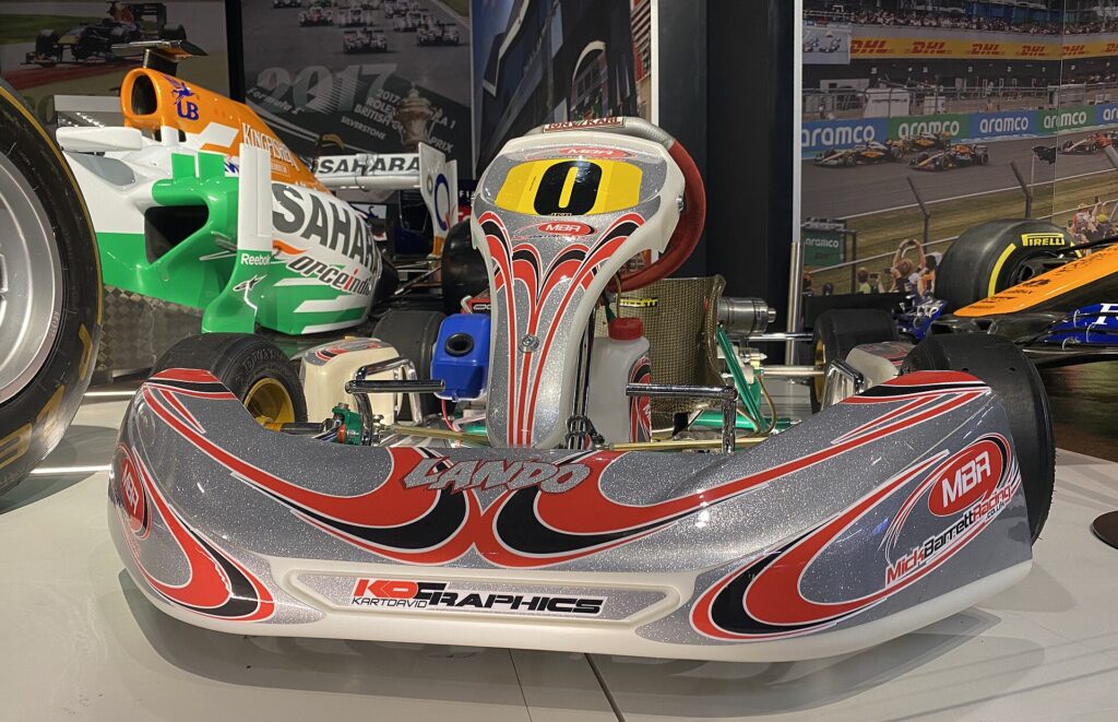 Silver, red and black Comer cadet kart with Lando written on the nose cone, on display at Silverstone Museum